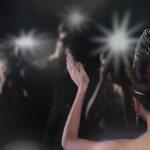 Back side view of Miss Pageant beauty contest with Silver Diamond Crown wave hand to many Photographers