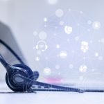 close up headset of call center and VOIP communication with futuristic virtual icon telecommunication technology on office table in monitoring room for network operation job concept