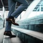 Businessman taking a step on stair with courage