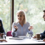 Mature leader boss give helpful information to young professionals