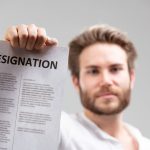 holding up a resignation letter