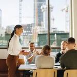 Business team applauding leader with values for successful strategy planning