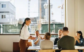 Business team applauding leader with values for successful strategy planning