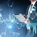 Businessman holding tablet for stocks