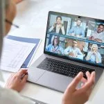 Remote teams having a videocall on financial report using laptop