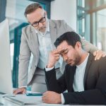 Business leader comforting employee with climate anxiety