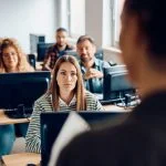 College student listening to the professor during lecture about AI