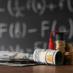 Coins, MBA ROI, dollar banknotes and graduation cap on wooden table