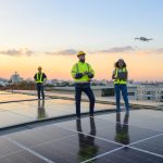A team of engineers flies a drone to plan the installation of an outdoor solar panel system. Installing solar cells on the roof Solar panels on the roof Workers install eco-technology solar power plan.