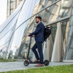 Smart mobility in the workplace. Businessman riding an electric vehicle going home after work