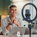 content creator with smartphone for social media or online vlog and live streaming.