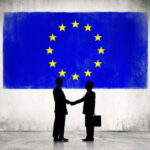 Two Business Person Shaking Hands with the European Union Flag