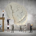 Huge human brain and many little businesspeople around. Concept of thinking new ideas