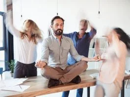 Elevating corporate culture - sitting on table and meditating