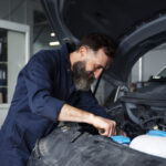 Male mechanic working on car in the auto repair shop