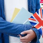 UK Rejoins - student holding book with flag